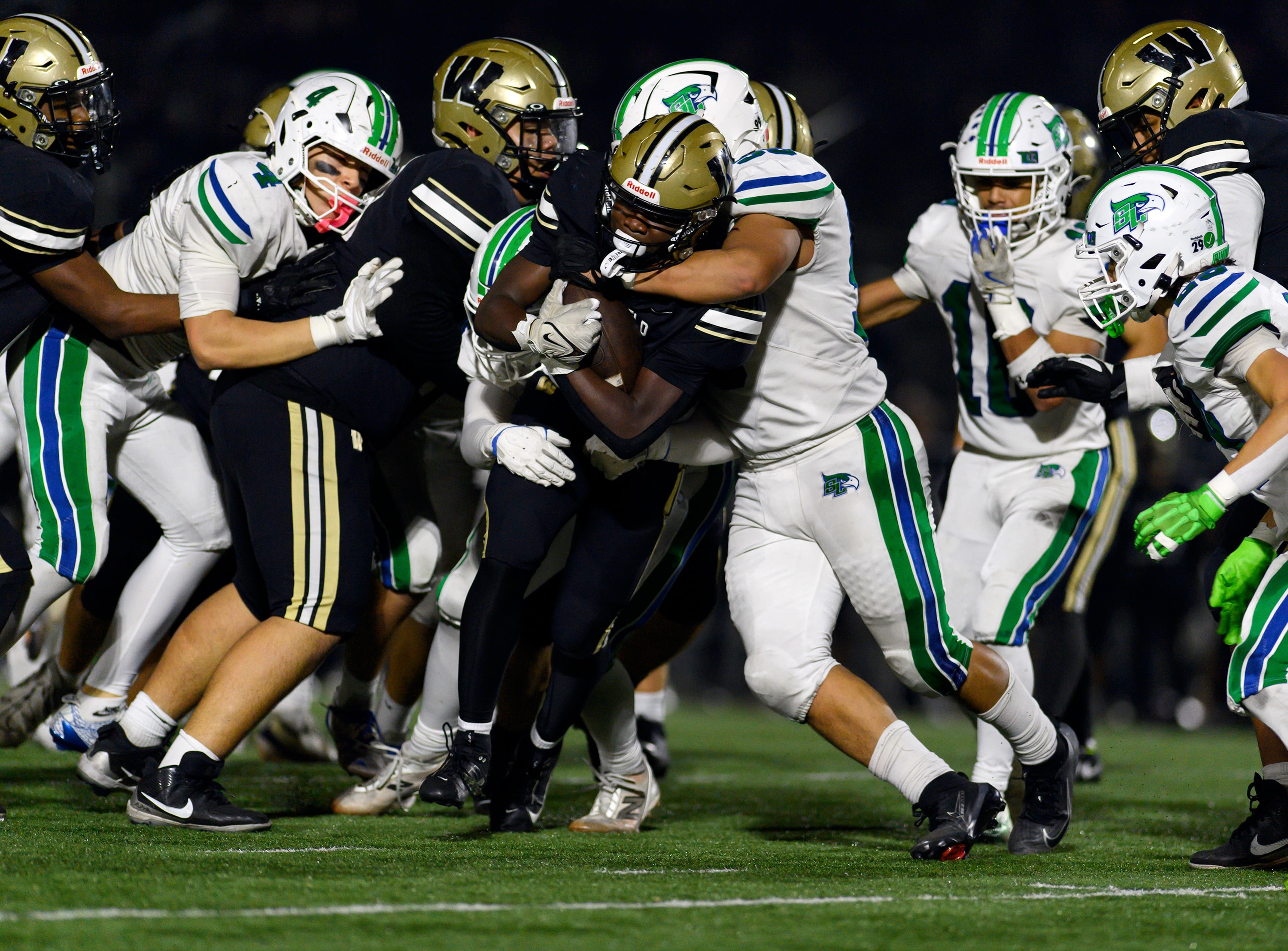 Football defensive stop in crowd of players