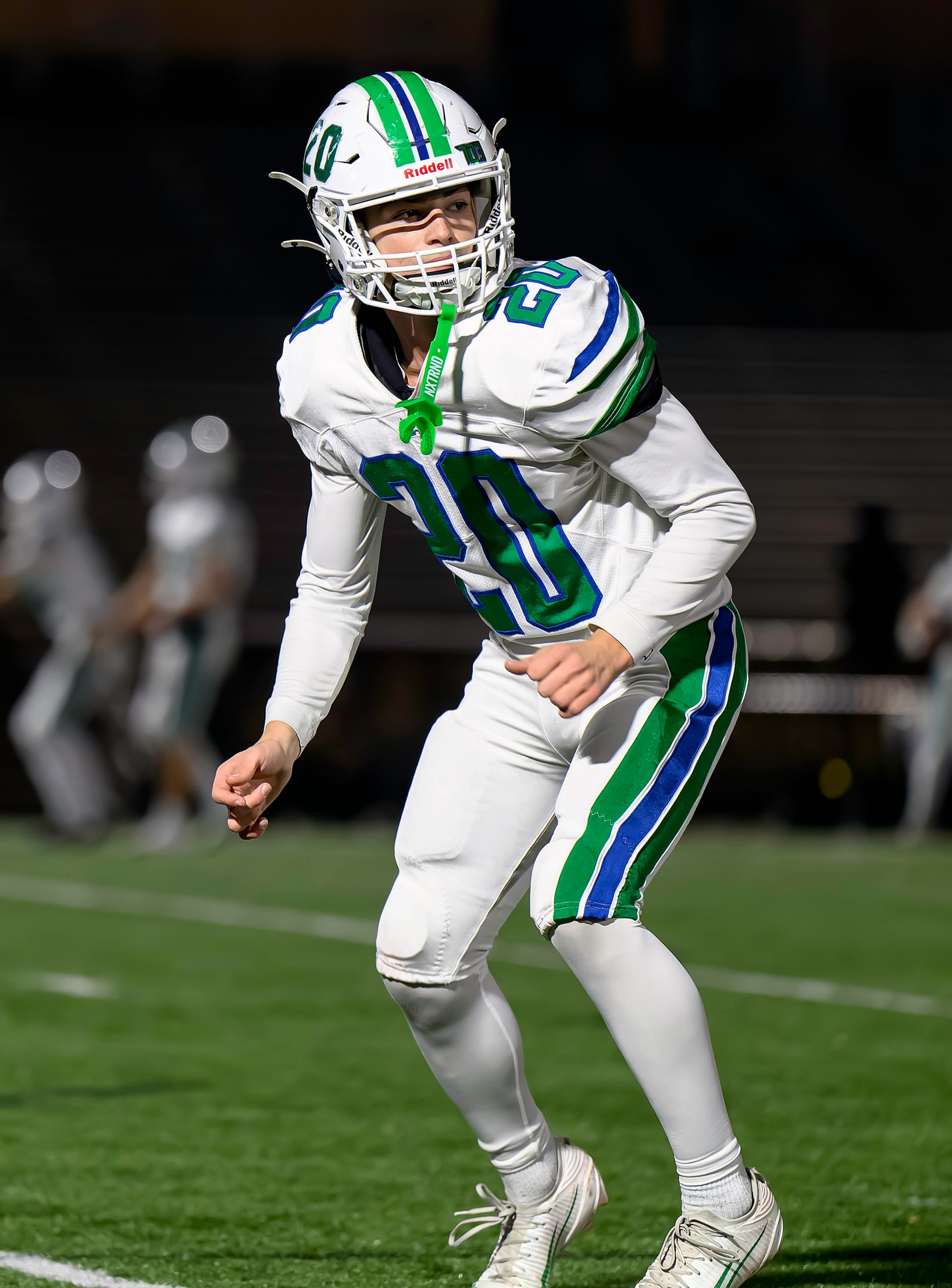 Football player in white uniform ready at the line